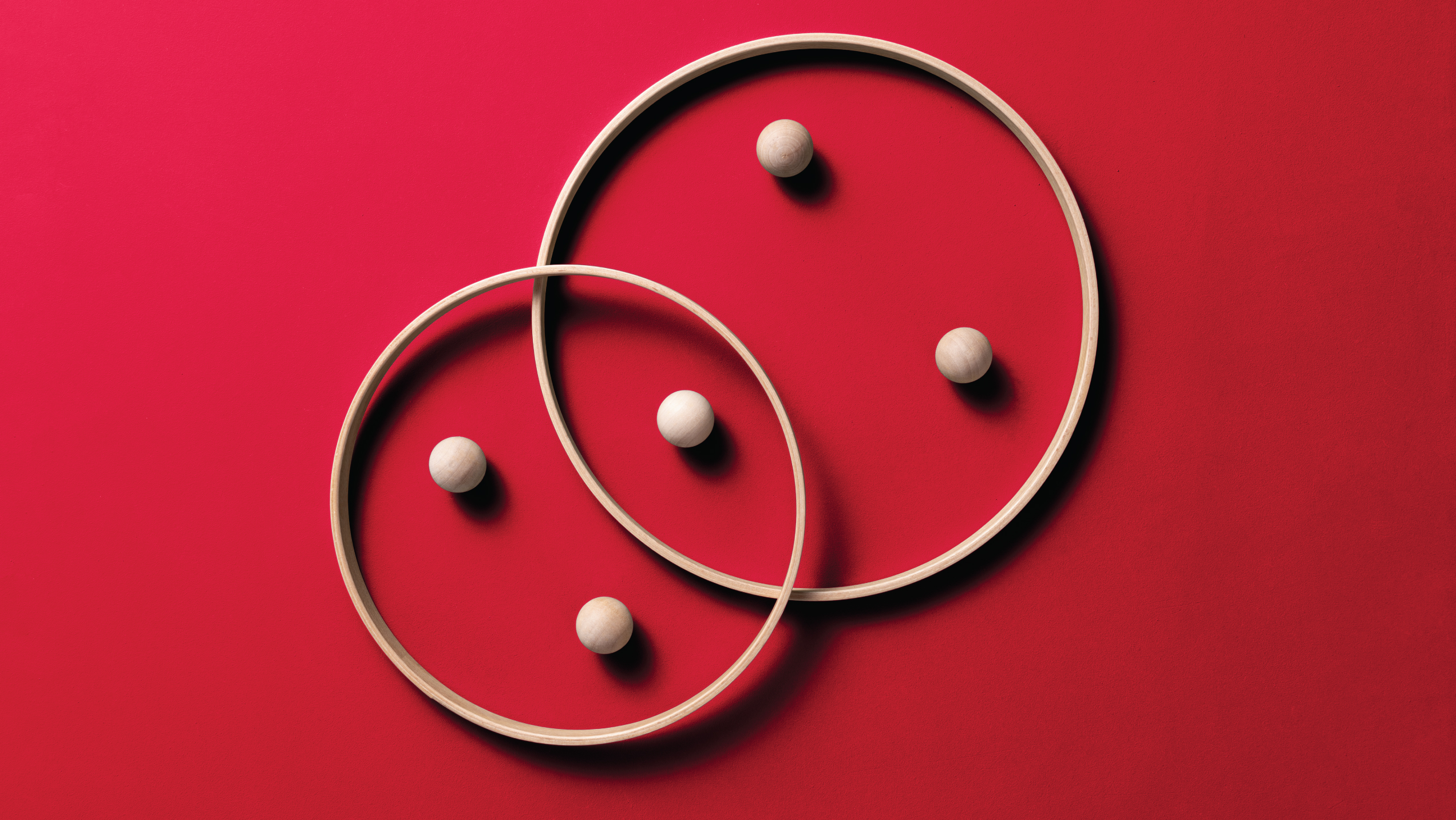 spheres in hoops on red background