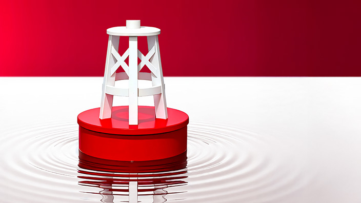 A white buoy-like structure with crisscross supports sits on top of a red circular base floating in calm water, creating gentle ripples and a reflection below, against a bold red-and-white background.