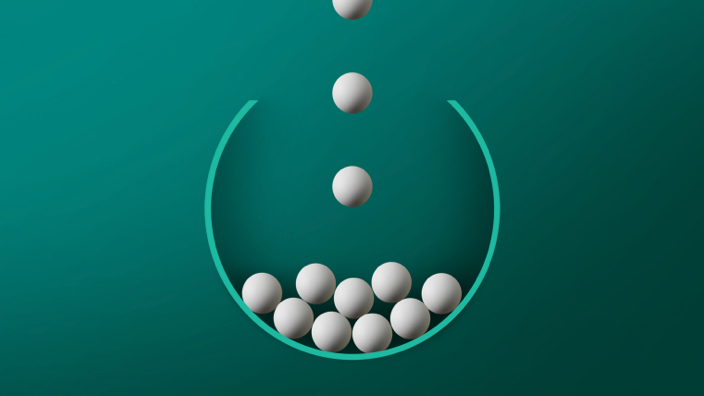 white balls falling into bucket