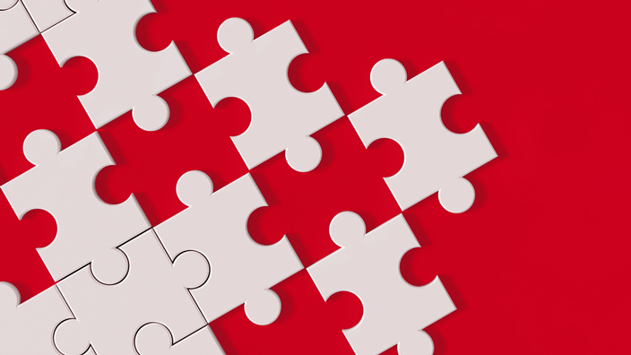 white puzzle pieces on red background
