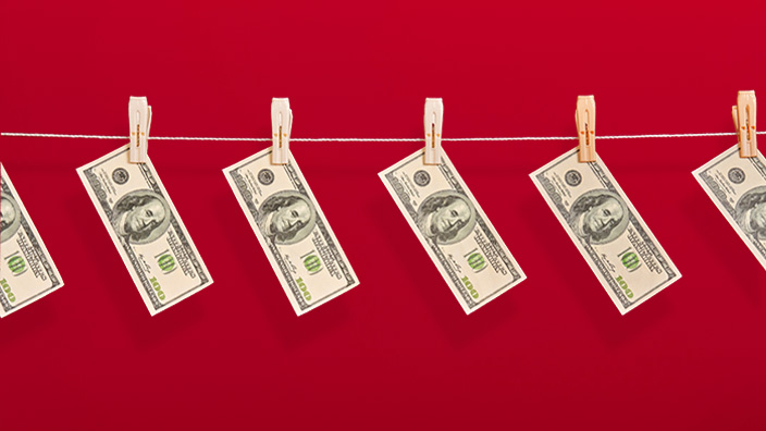 dollar bills hanging on a line